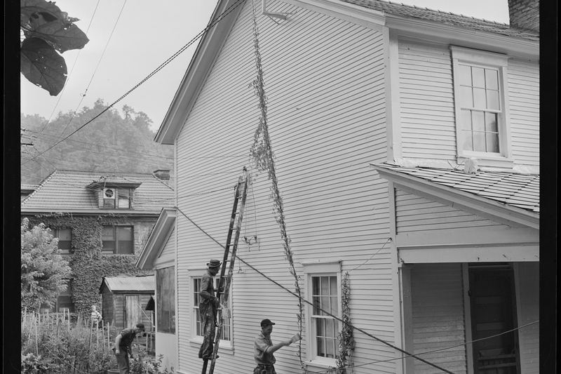 Painters working on company-owned houses