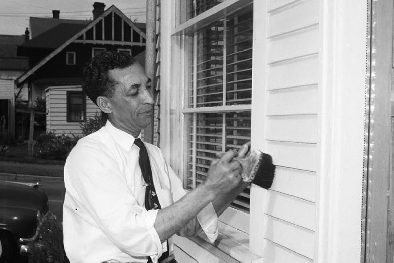 Man painting a house exterior